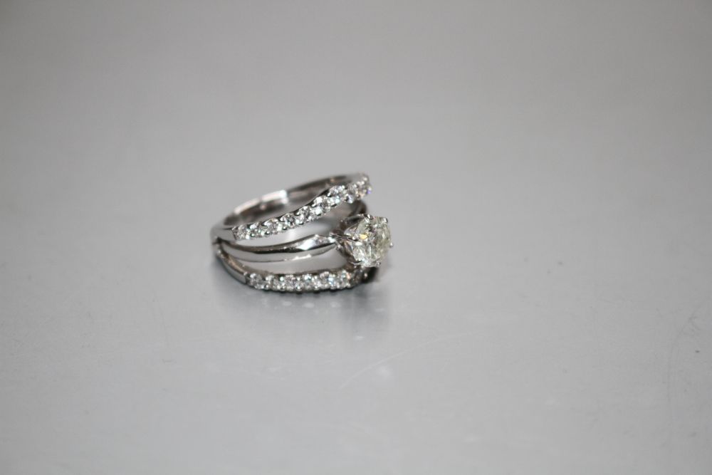 A modern 14kt white metal and triple band diamond dress ring,